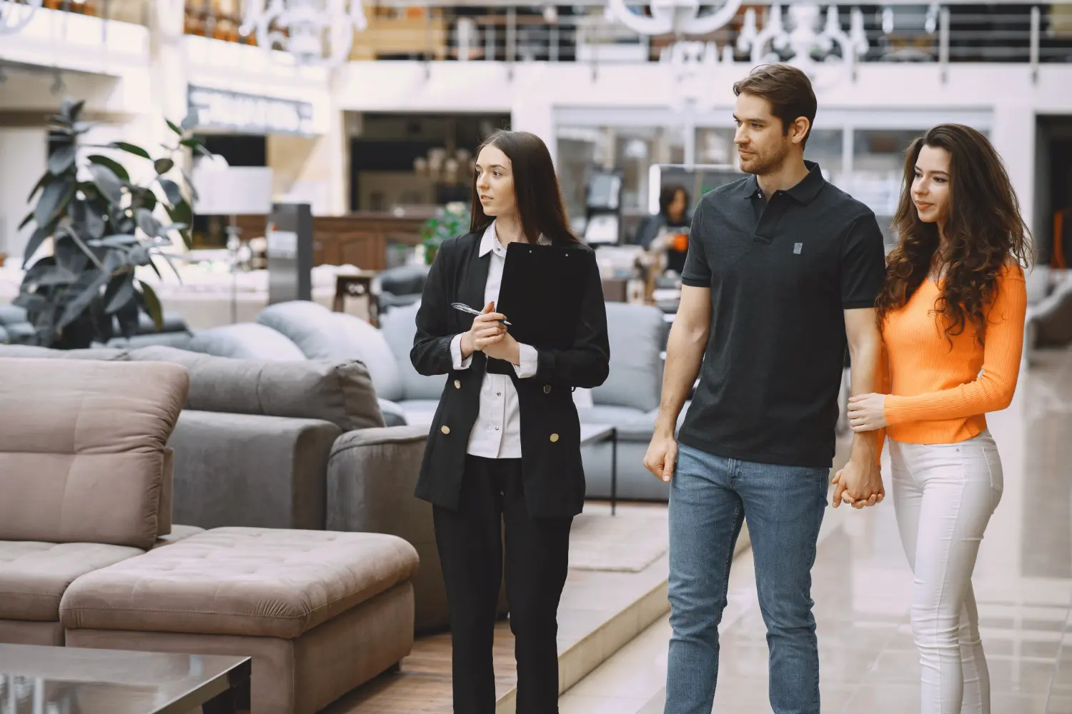 Couple with salesman in furniture store